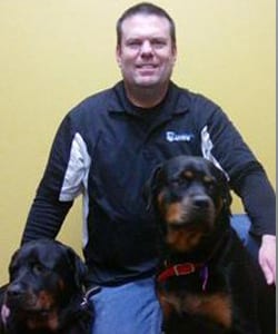 Leader of the Pack Canine Institute dog trainer with two rottweilers